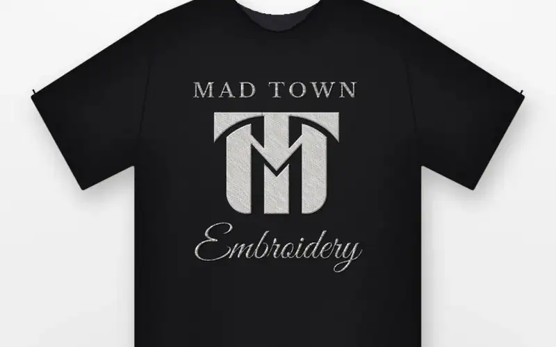 Black t-shirt with the MadTown logo embroidered in white thread